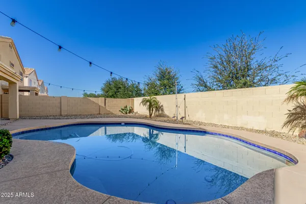 a view of a swimming pool with a chair