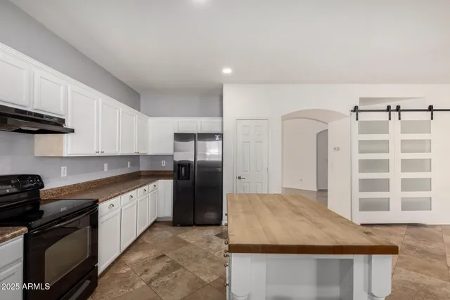 a view of a room with a sink and wooden floor