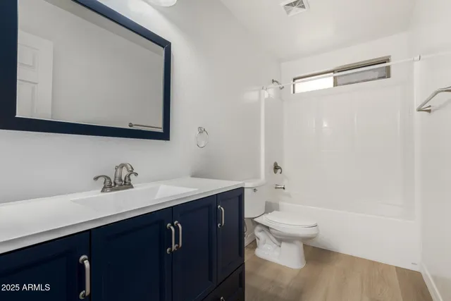a view of a bedroom with a large bed and chandelier fan
