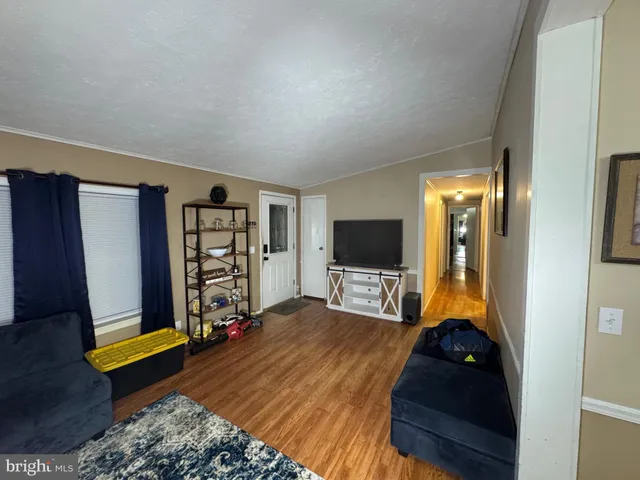 a bedroom with bed and a flat tv screen