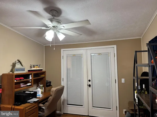 a view of a workspace with furniture and closet