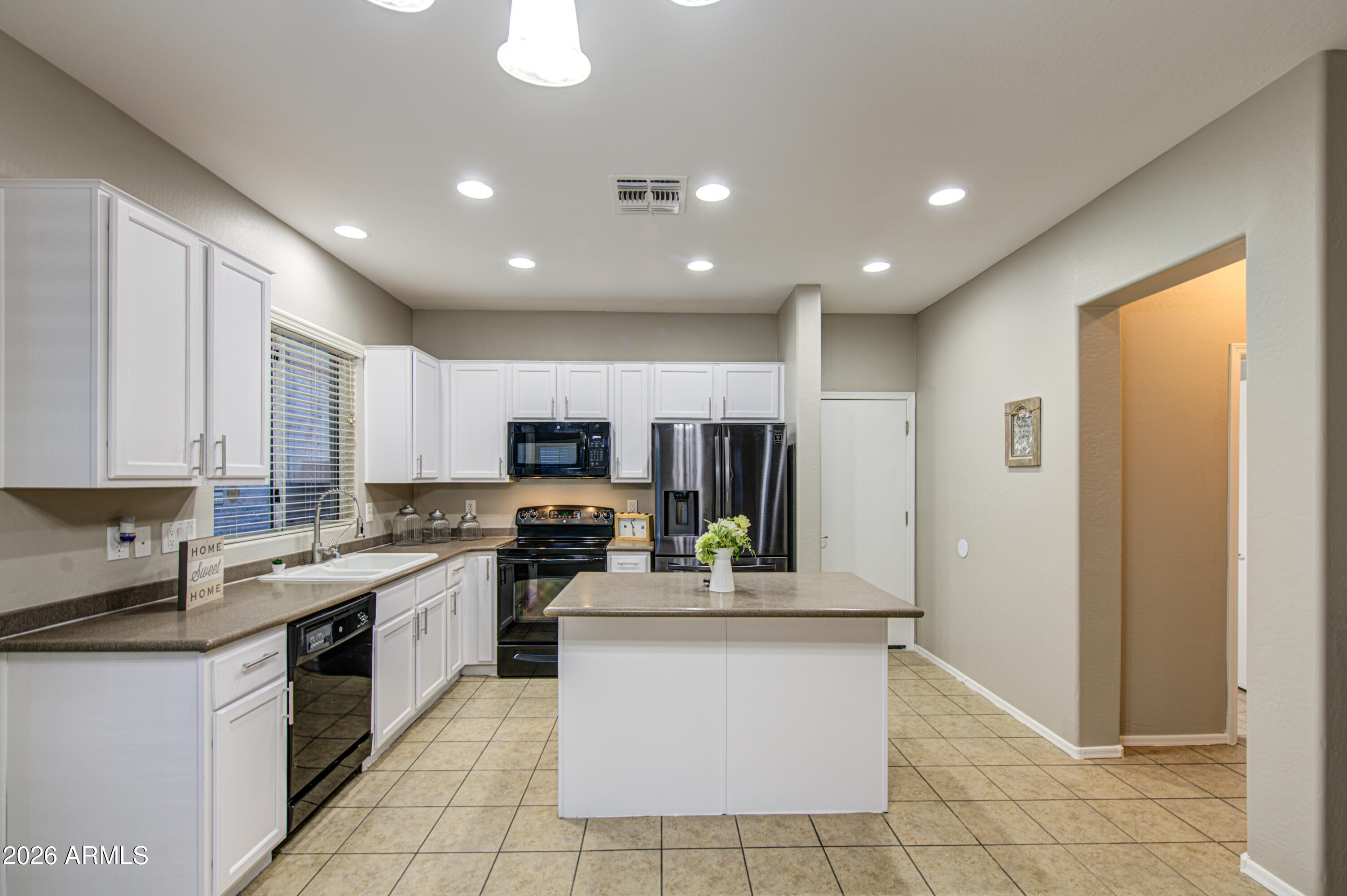 7759 West Monte Vista Road Phoenix, AZ 85035 - Photo 13 of 43 a kitchen with stainless steel appliances granite countertop a stove top oven a sink a refrigerator and a granite counter tops