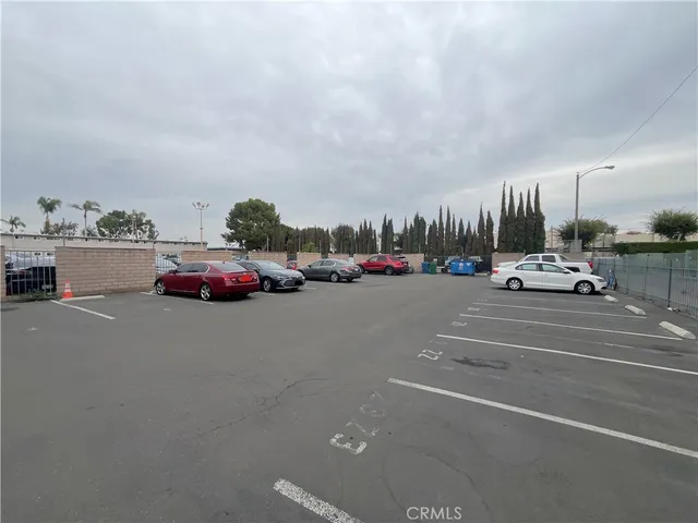 a view of a city street with parked cars