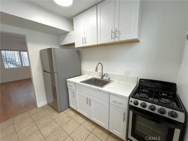 a kitchen with a stove and a refrigerator