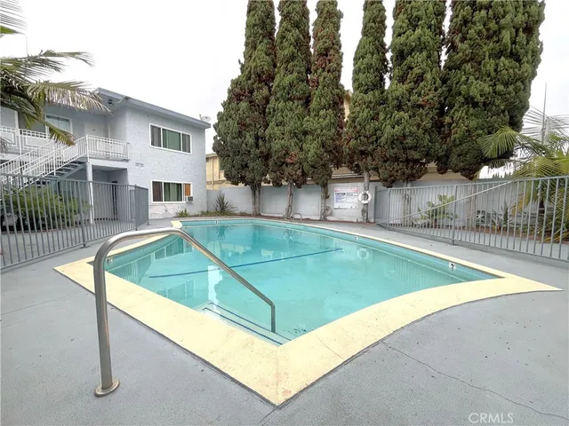 a view of a backyard with a small pool and sitting area