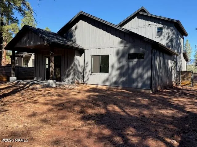 a white bed sitting in a bedroom next to a window