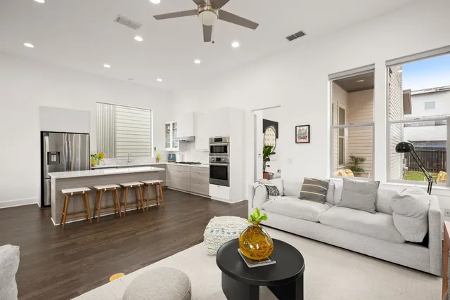 a living room with furniture and wooden floor