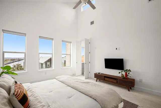 a bedroom with a large bed and a window