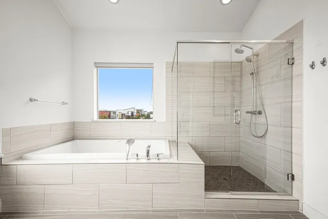 a bathroom with a bathtub and a shower
