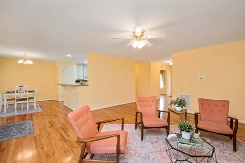 a living room with furniture and a chandelier