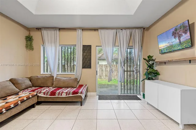 a living room with furniture and a floor to ceiling window