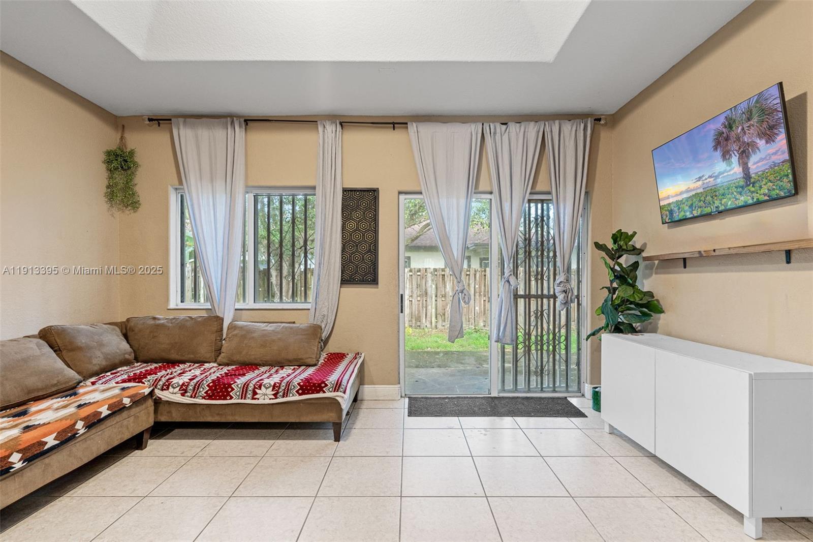 211 Southwest 15th Terrace Homestead, FL 33030 - Photo 12 of 26 a living room with furniture and a floor to ceiling window