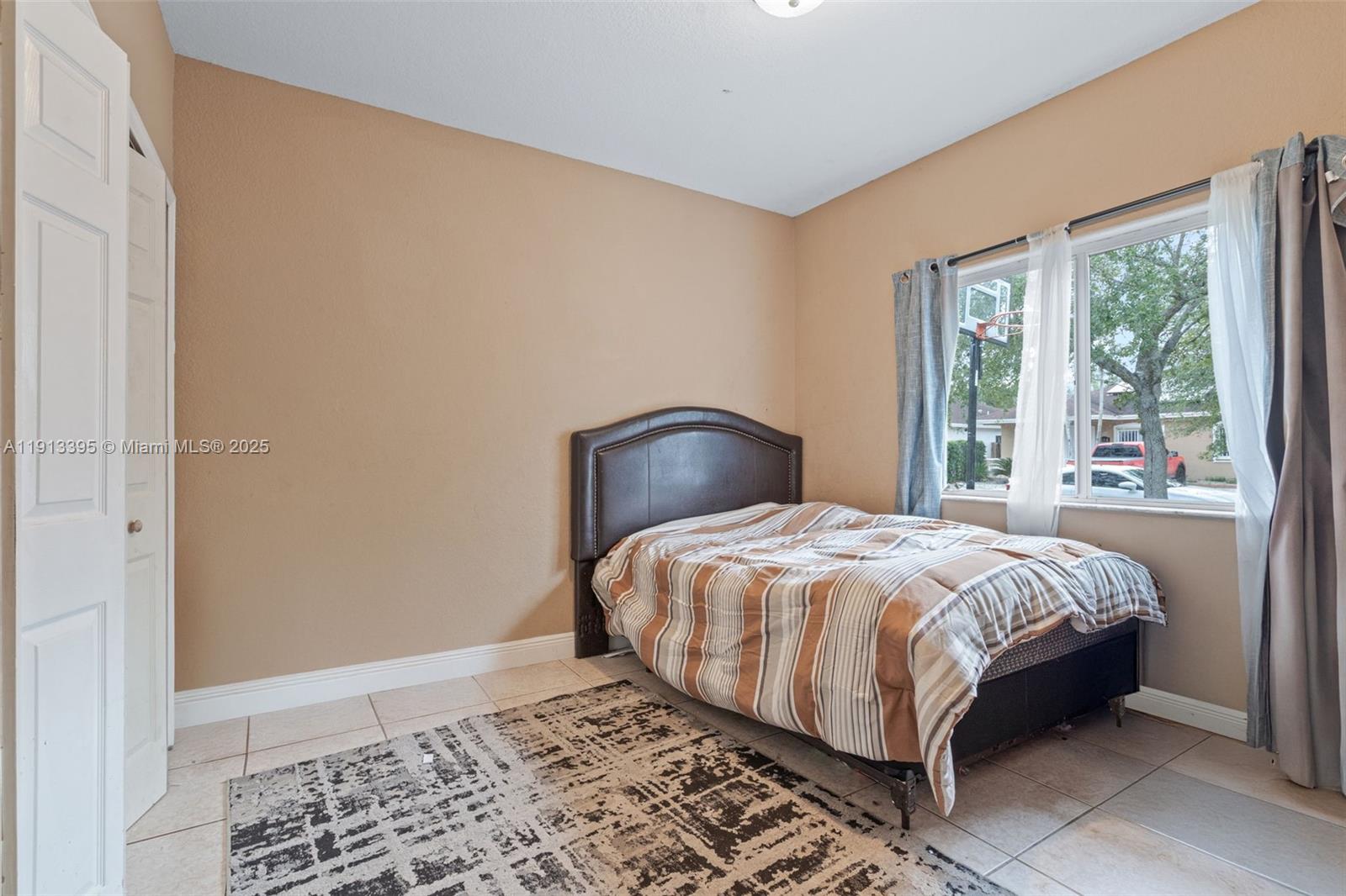 211 Southwest 15th Terrace Homestead, FL 33030 - Photo 17 of 26 a bedroom with a bed and a window