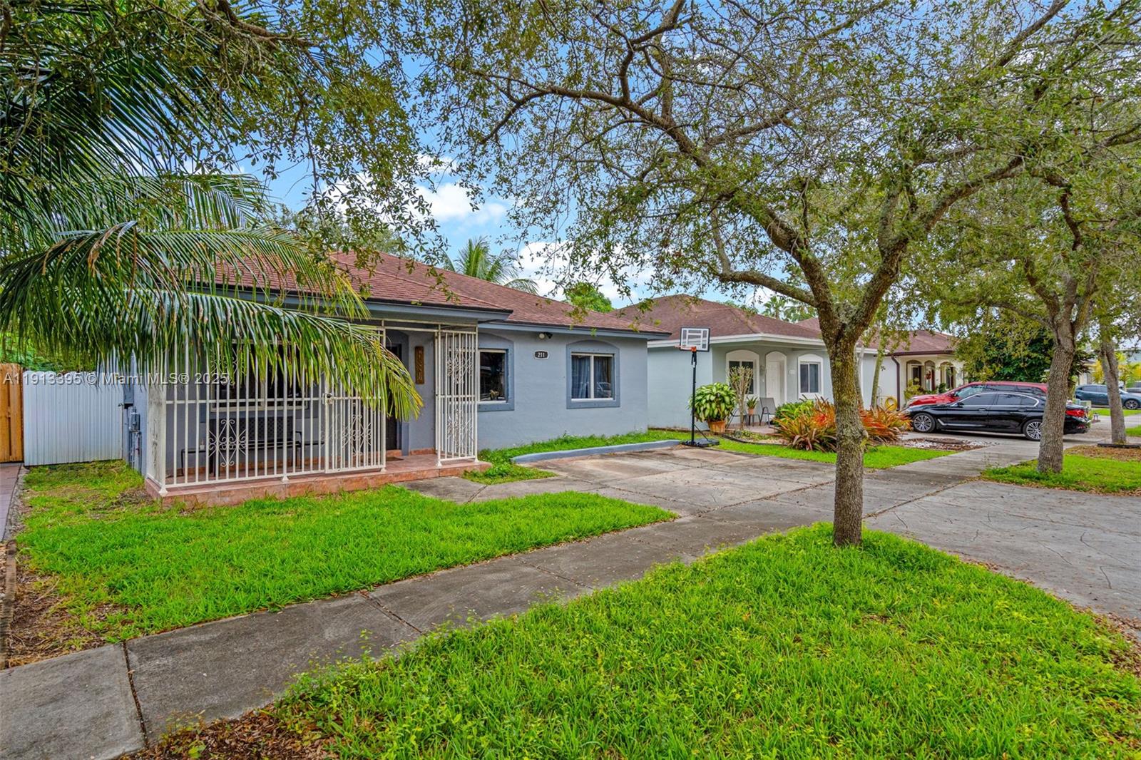 211 Southwest 15th Terrace Homestead, FL 33030 - Photo 2 of 26 a front view of a house with a yard and porch