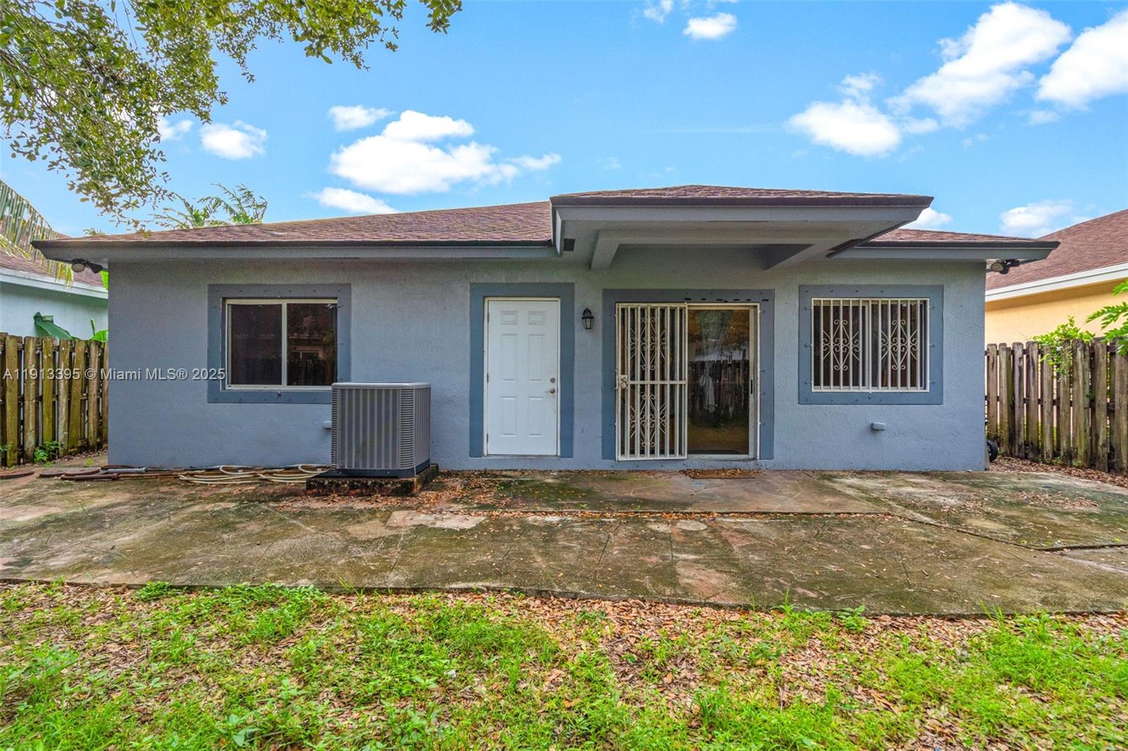 211 Southwest 15th Terrace Homestead, FL 33030 - Photo 23 of 26 a view of yellow house with a yard and potted plants