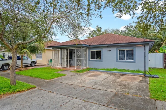 a house that has a tree in front of it