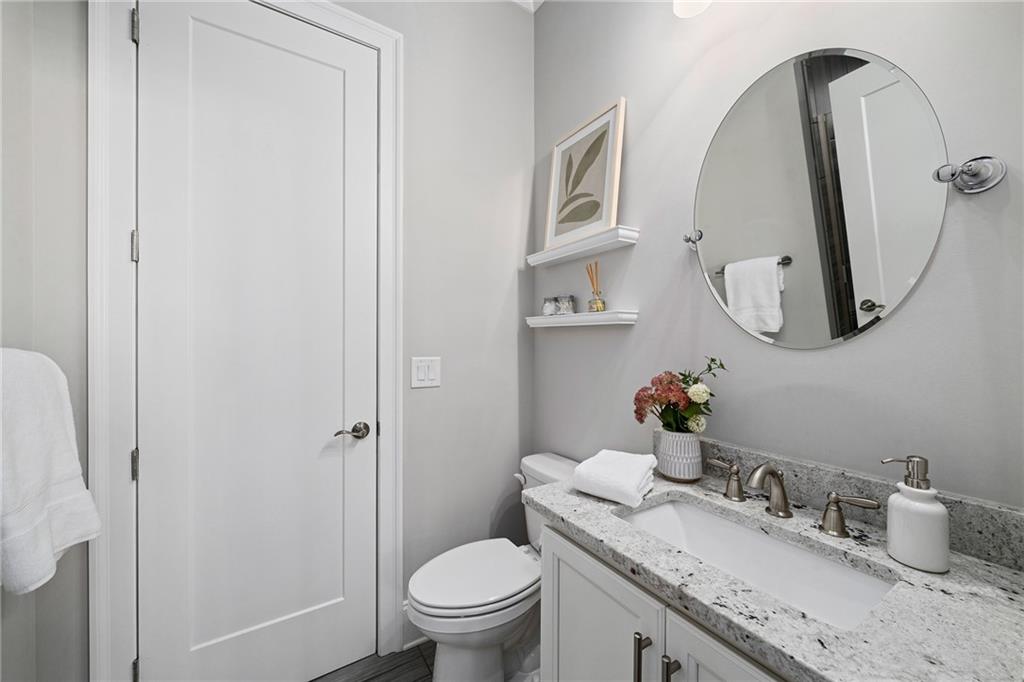 165 Rowan Avenue Alpharetta, GA 30009 - Photo 11 of 84 a bathroom with a granite countertop sink vanity mirror and toilet