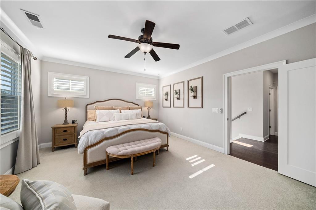 165 Rowan Avenue Alpharetta, GA 30009 - Photo 33 of 84 a bedroom with a bed and a chandelier