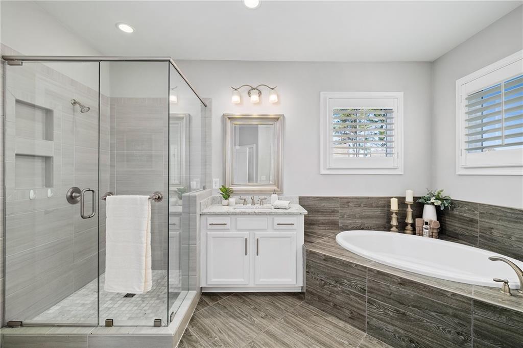 165 Rowan Avenue Alpharetta, GA 30009 - Photo 35 of 84 a spacious bathroom with a double vanity sink mirror and shower
