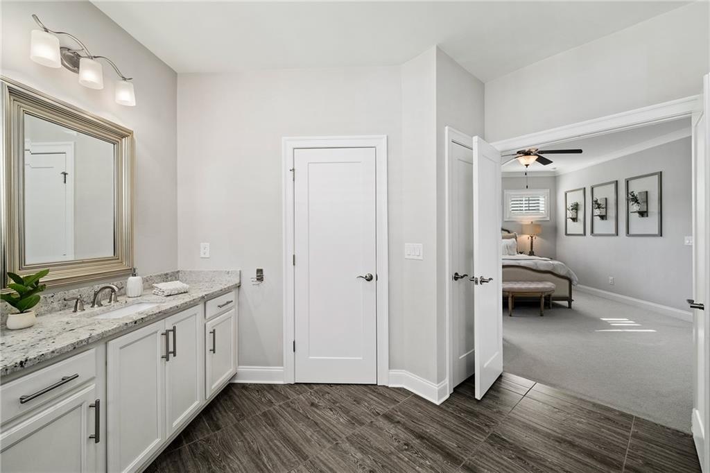 165 Rowan Avenue Alpharetta, GA 30009 - Photo 36 of 84 a en suite bathroom with a granite countertop double vanity sink and a mirror