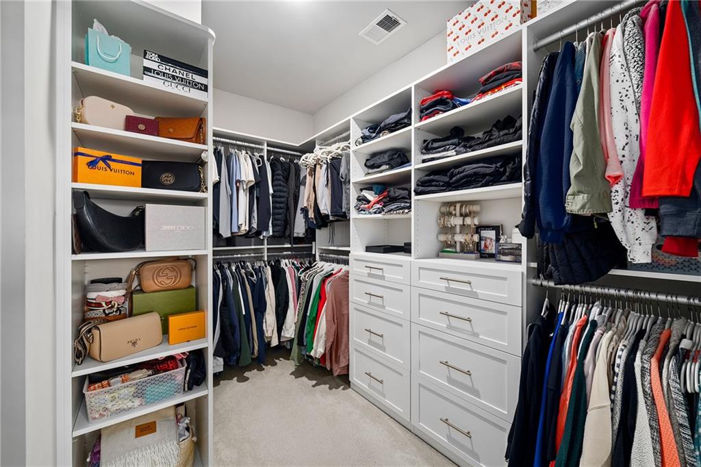 165 Rowan Avenue Alpharetta, GA 30009 - Photo 37 of 84 a view of walk in closet with clothes and shoes