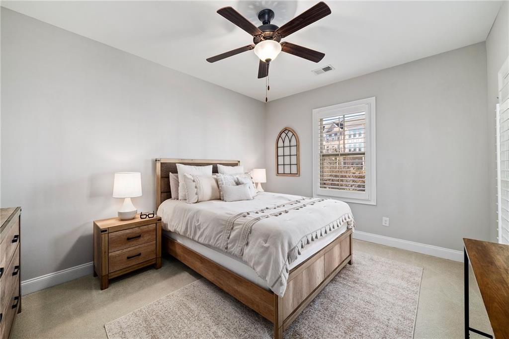 165 Rowan Avenue Alpharetta, GA 30009 - Photo 40 of 84 a bedroom with a bed a window and a chandelier