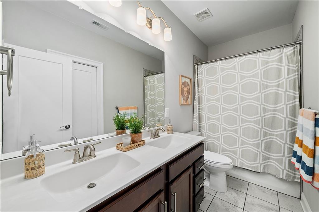 165 Rowan Avenue Alpharetta, GA 30009 - Photo 41 of 84 a bathroom with a sink and a mirror