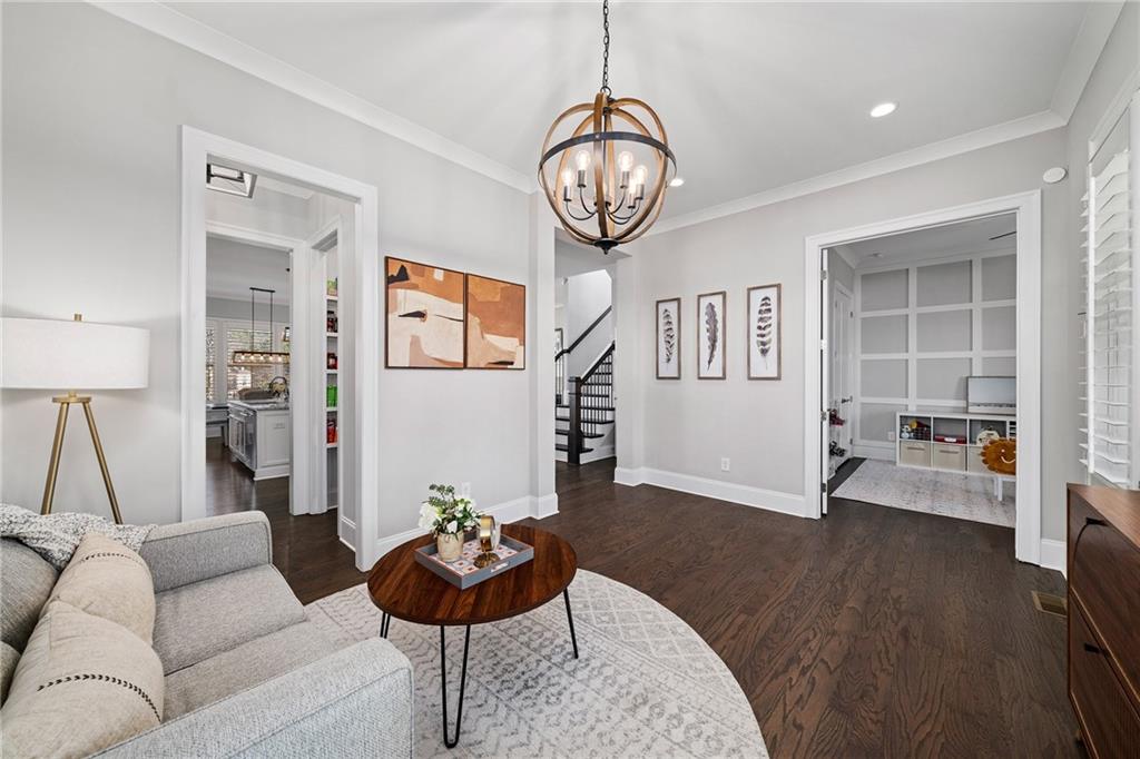 165 Rowan Avenue Alpharetta, GA 30009 - Photo 8 of 84 a living room with furniture a clock and a large window