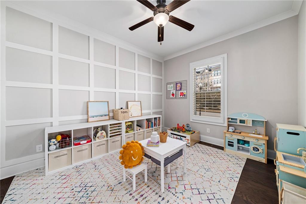 165 Rowan Avenue Alpharetta, GA 30009 - Photo 9 of 84 a living room with furniture a baby crib and a window