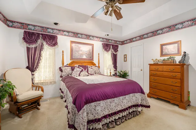 a bedroom with a bed dresser and a window