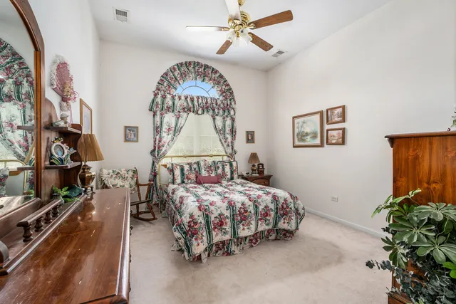 a bedroom with bed and a chandelier