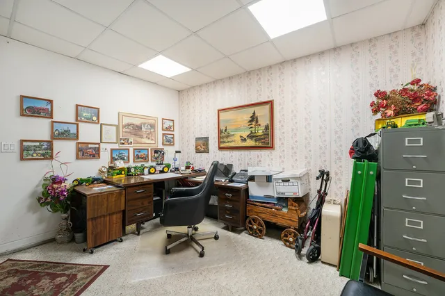 a view of a workspace with furniture and a window