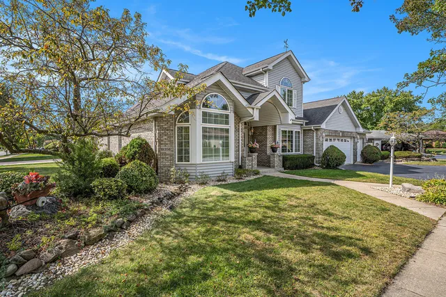 a view of a house with backyard and trees