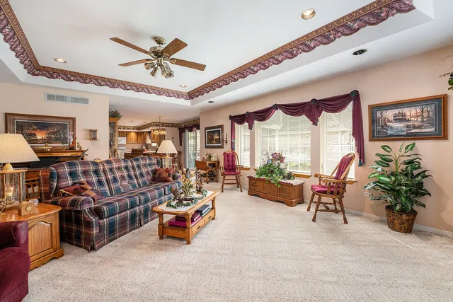 a living room with lots of furniture and a large window