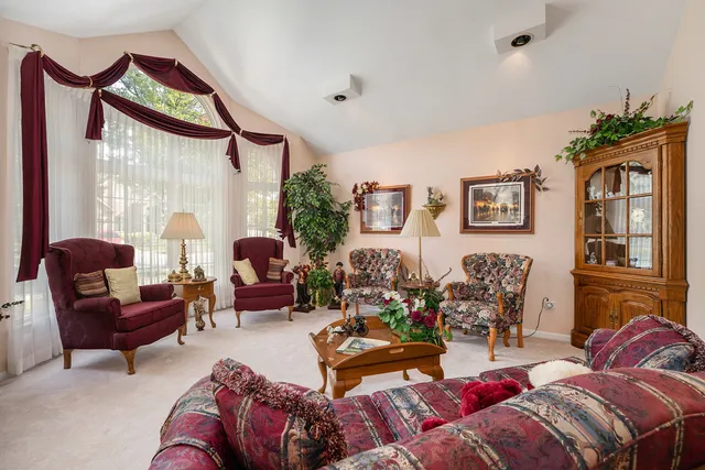 a living room with furniture chess board and a window