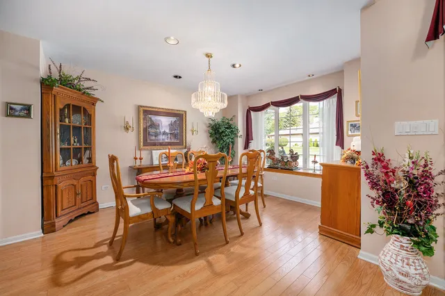 a view of a dining room with furniture and chandelier