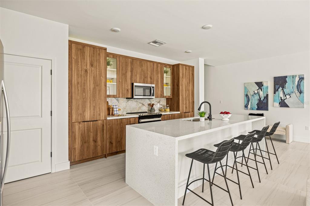 6336 Chorus Drive Mascotte, FL 34753 - Photo 14 of 21 a kitchen with stainless steel appliances a table and chairs