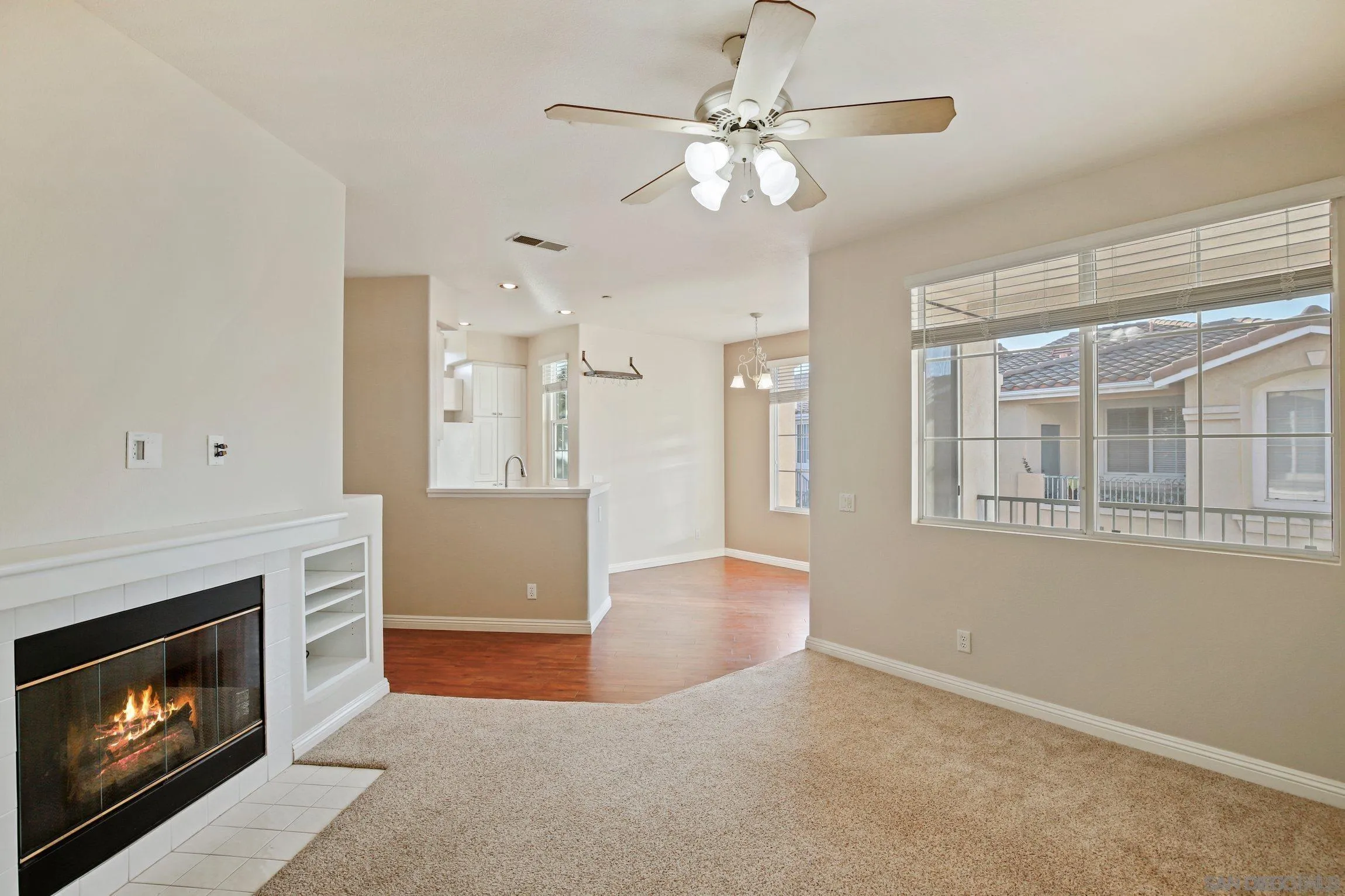 10766 Sabre Hill Drive, Unit 258 San Diego, CA 92128 - Photo 2 of 18 a view of an empty room with kitchen and fireplace