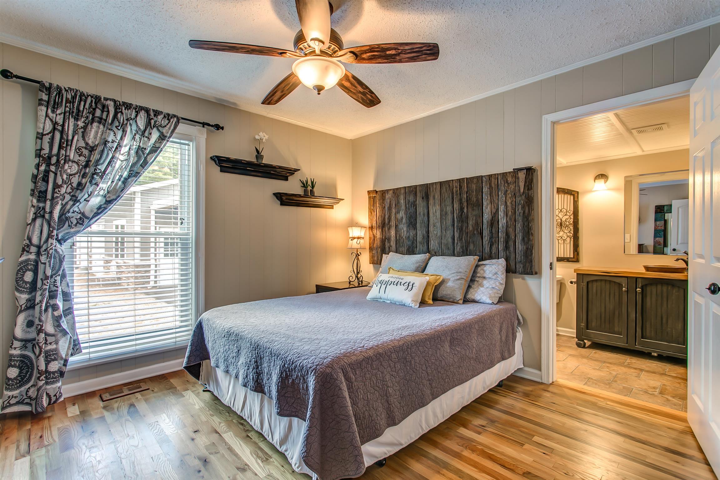 4432 Harpeth School Road Franklin, TN 37064 - Photo 14 of 30 The sunlit master bedroom features an eye-catching ceiling fan and an attached full bath. Hardwood flooring, ceiling fan and crown molding add to the charm.