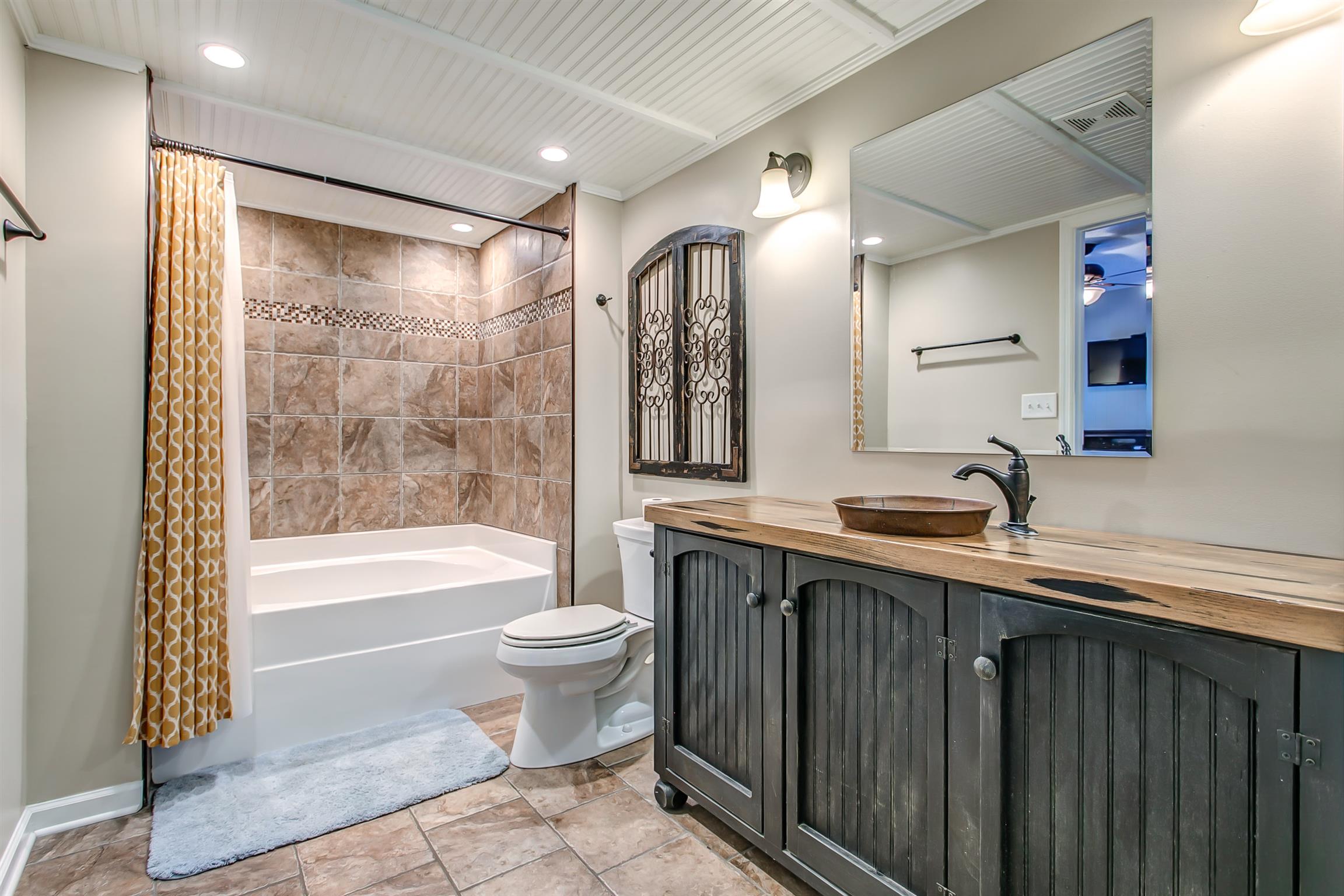 4432 Harpeth School Road Franklin, TN 37064 - Photo 15 of 30 Master bath with tile flooring and tile tub surround. Check out the rustic vanity.