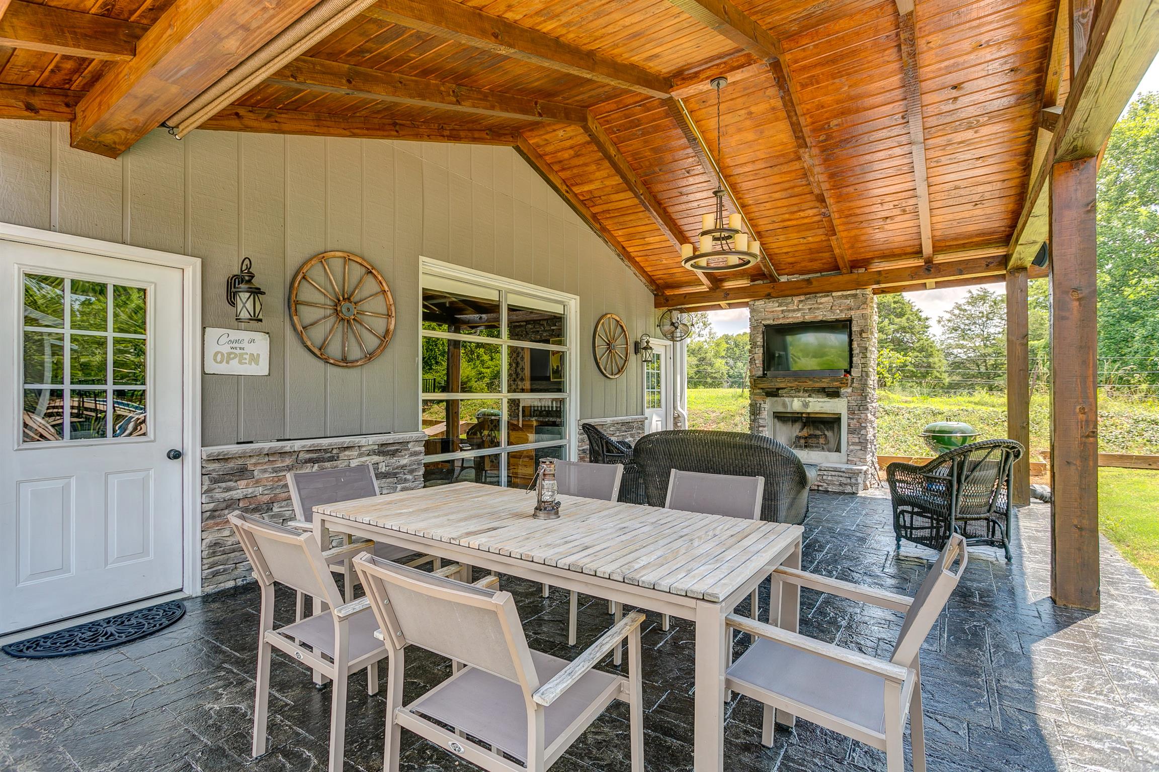 4432 Harpeth School Road Franklin, TN 37064 - Photo 24 of 30 Enjoy a meal al fresco in the covered, outdoor patio. Covered patio with wood plank ceiling, stone patio floor and stack stone fireplace.
