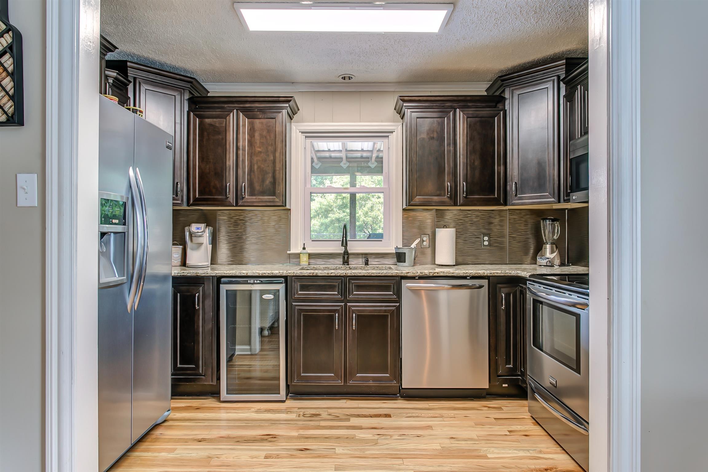 4432 Harpeth School Road Franklin, TN 37064 - Photo 8 of 30 A small kitchen with plenty of storage sits adjacent to the home's living room.