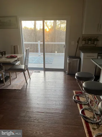 a view of workspace with wooden floor windows