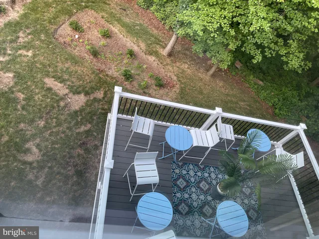 a view of balcony with table and chairs