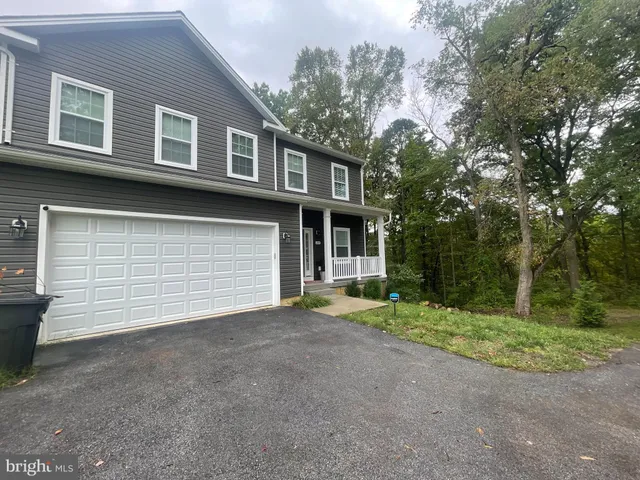 a view of a house with a yard and garage