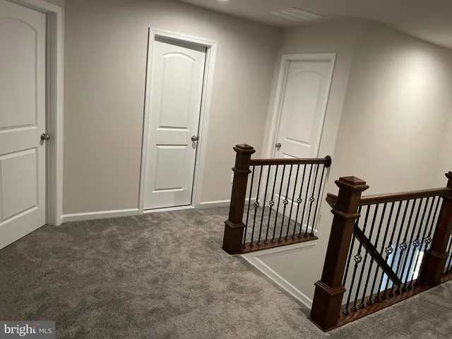 a view of a hallway with entryway and front door