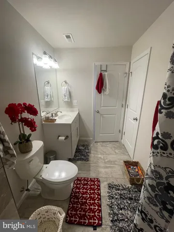 a bathroom with a toilet sink and mirror