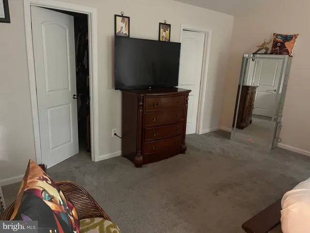 a spacious bedroom with a bed and a chandelier