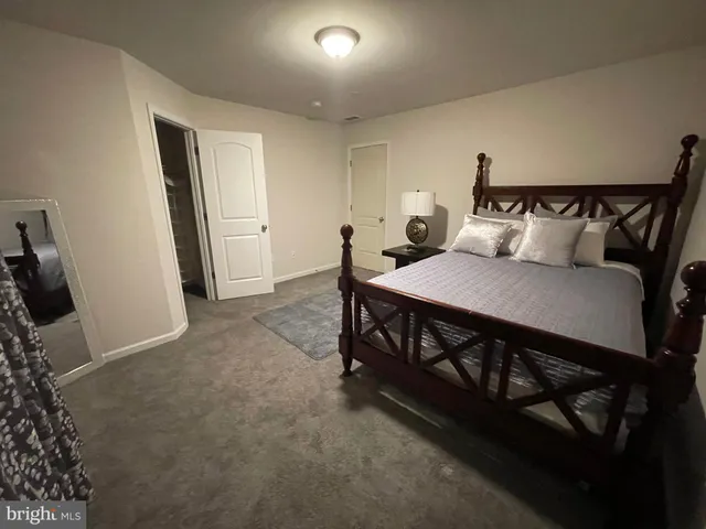 a bedroom with bed and window