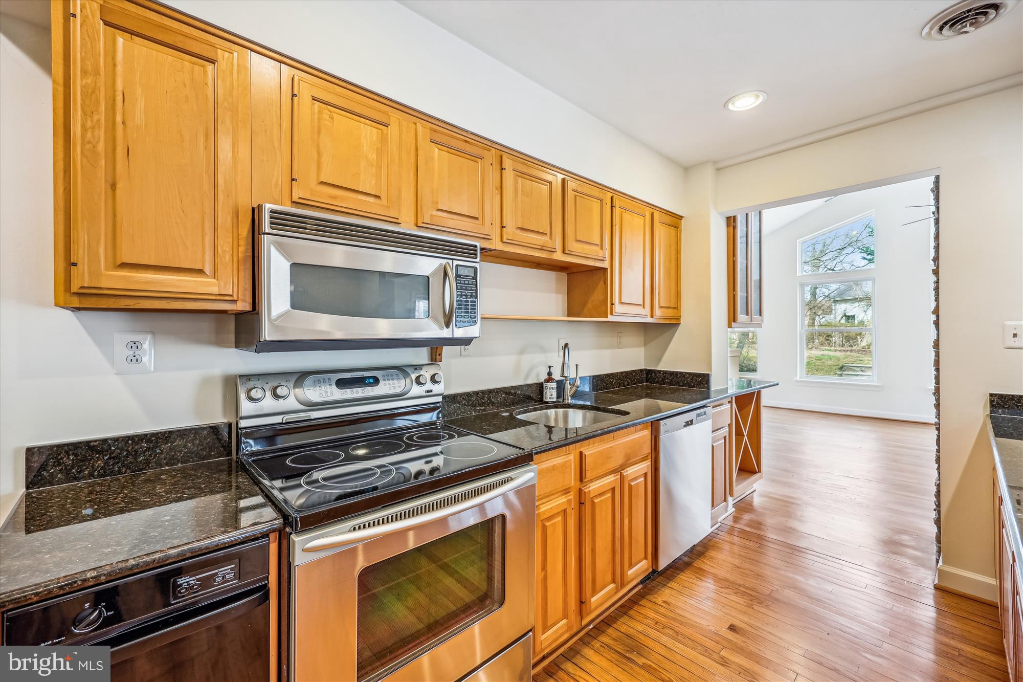 411 Pershing Drive Silver Spring, MD 20910 - Photo 15 of 64 a kitchen with stainless steel appliances granite countertop a stove a sink and a microwave